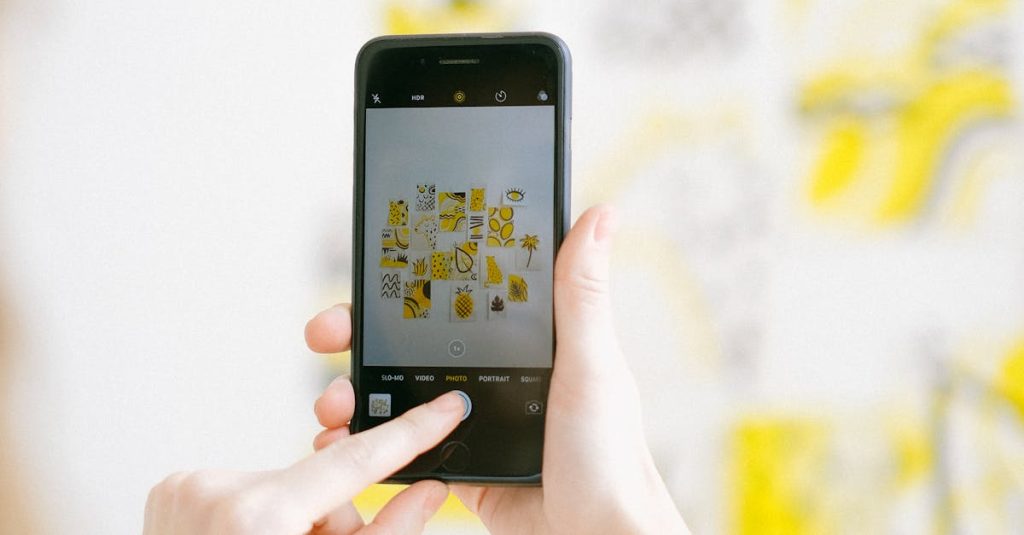 Person photographing colorful artwork with a smartphone in bright light.